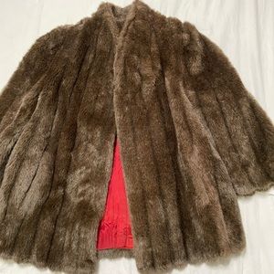 Beautiful brown faux fur coat. It could be real fur but not 100%.
